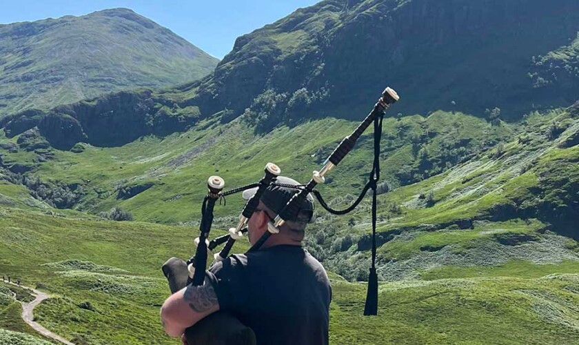 Bagpipe player in the Scottish Highlands